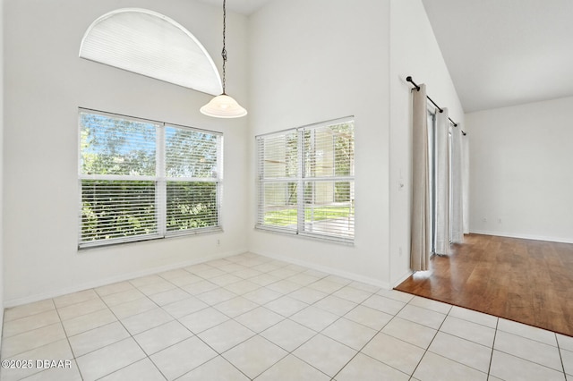 918 Brookridge Ln, Ormond Beach, FL 32174 - unfurnished room with high vaulted ceiling, light wood-style flooring, and a barn door