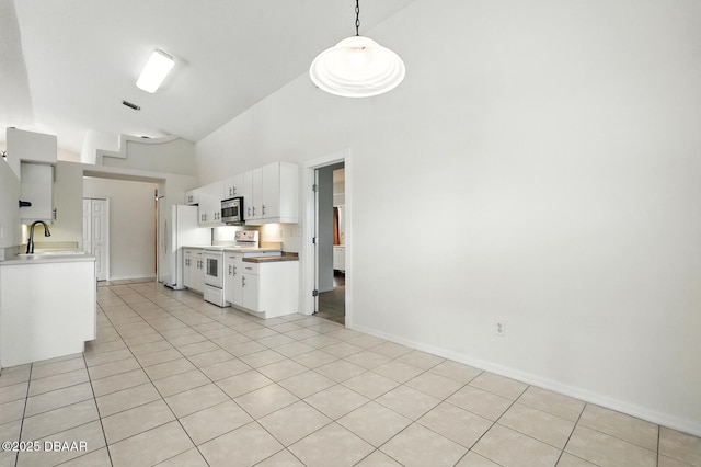 918 Brookridge Ln, Ormond Beach, FL 32174 - kitchen with electric stove, light countertops, high vaulted ceiling, white cabinetry, and light tile patterned floors