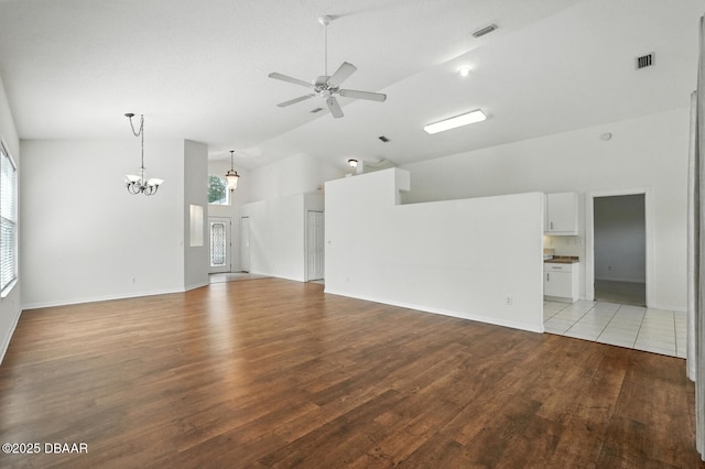 918 Brookridge Ln, Ormond Beach, FL 32174 - unfurnished living room with high vaulted ceiling, a ceiling fan, wood finished floors, and a chandelier