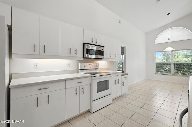 918 Brookridge Ln, Ormond Beach, FL 32174 - kitchen with stainless steel appliances, light countertops, pendant lighting, light tile patterned floors, and vaulted ceiling