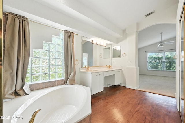 918 Brookridge Ln, Ormond Beach, FL 32174 - full bathroom with a bath, double vanity, ceiling fan, vaulted ceiling, and wood finished floors