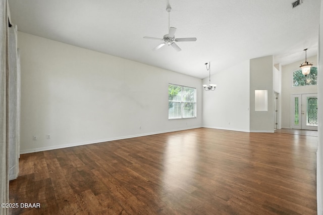 918 Brookridge Ln, Ormond Beach, FL 32174 - unfurnished living room featuring lofted ceiling, wood finished floors, a ceiling fan, and a chandelier