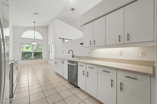 918 Brookridge Ln, Ormond Beach, FL 32174 - kitchen featuring light tile patterned flooring, white appliances, light countertops, high vaulted ceiling, and white cabinetry