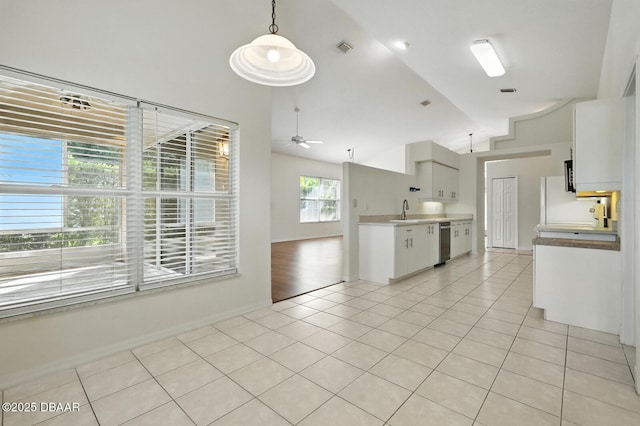 918 Brookridge Ln, Ormond Beach, FL 32174 - kitchen featuring light tile patterned floors, a ceiling fan, white cabinets, light countertops, and stainless steel dishwasher