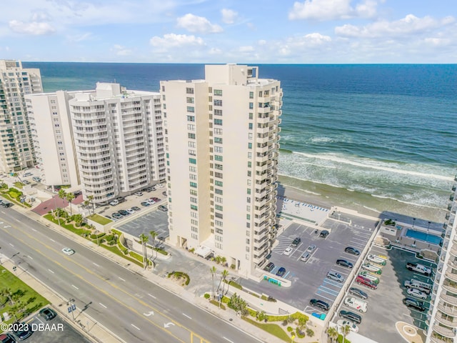 birds eye view of property with a beach view and a water view