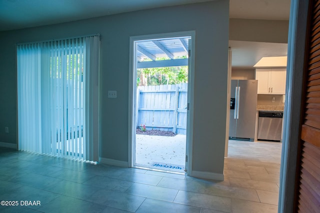 2 Springwood Sq, Port Orange, FL 32129 - doorway featuring baseboards and light tile patterned floors