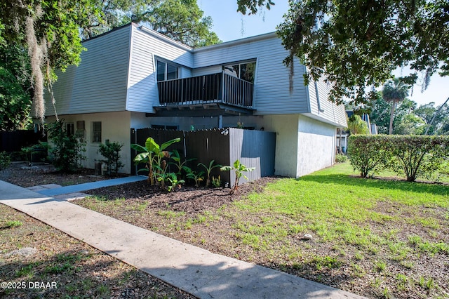 2 Springwood Sq, Port Orange, FL 32129 - view of front of house featuring stucco siding and a balcony
