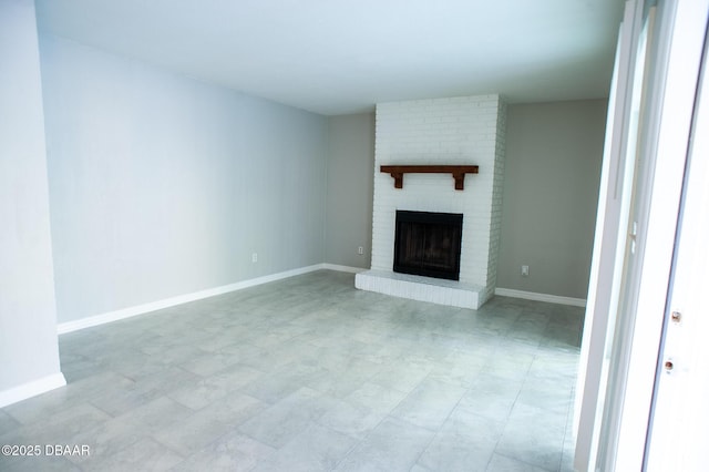 2 Springwood Sq, Port Orange, FL 32129 - unfurnished living room featuring a brick fireplace and baseboards