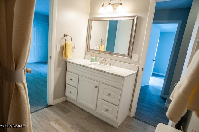 2 Springwood Sq, Port Orange, FL 32129 - bathroom with wood finished floors, vanity, and baseboards