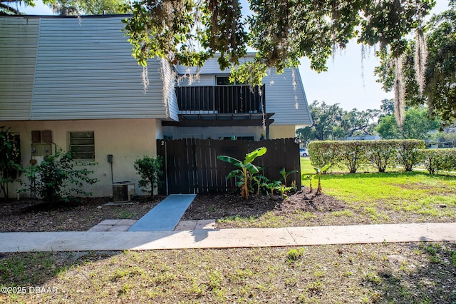 2 Springwood Sq, Port Orange, FL 32129 - view of front of home with stucco siding, central AC, and a balcony