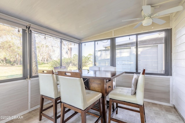 sunroom with vaulted ceiling and a ceiling fan