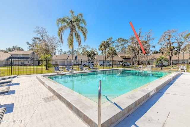 community pool with a residential view and fence