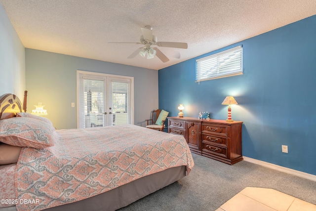 carpeted bedroom with a textured ceiling, french doors, multiple windows, and baseboards