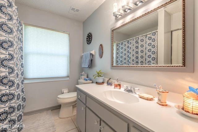 full bathroom with visible vents, toilet, tile patterned flooring, a textured ceiling, and vanity