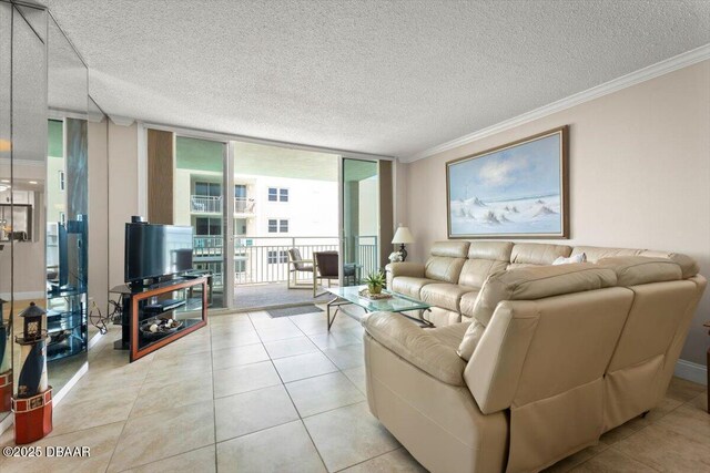 4505 S Atlantic Ave Unit 605, Ponce Inlet, FL 32127 - living room featuring expansive windows, crown molding, a textured ceiling, and light tile patterned flooring