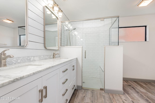 685 Middlebury Loop, New Smyrna Beach, FL 32168 - full bathroom featuring double vanity, wood finished floors, a stall shower, and baseboards