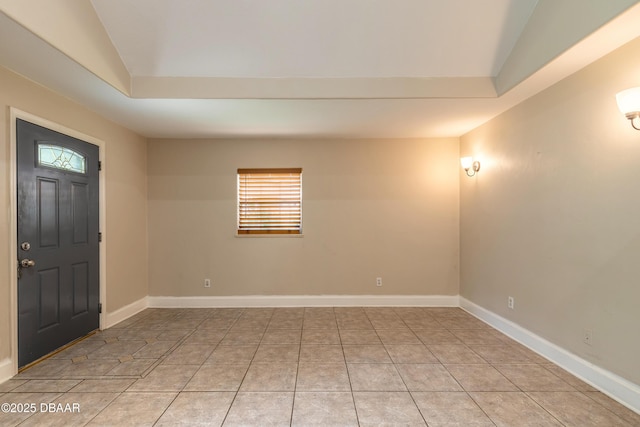 121 Palm Dr, Daytona Beach, FL 32117 - entrance foyer with vaulted ceiling, light tile patterned floors, and baseboards