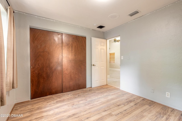 121 Palm Dr, Daytona Beach, FL 32117 - unfurnished bedroom with a closet, wood finished floors, and baseboards