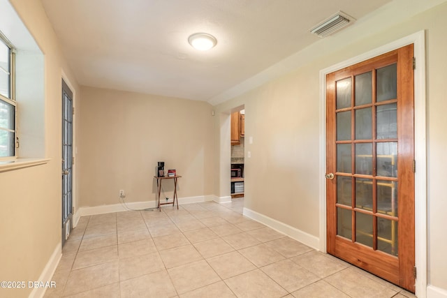 121 Palm Dr, Daytona Beach, FL 32117 - empty room featuring light tile patterned floors and baseboards