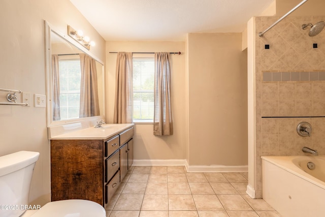 121 Palm Dr, Daytona Beach, FL 32117 - full bathroom featuring toilet, vanity, washtub / shower combination, tile patterned flooring, and baseboards