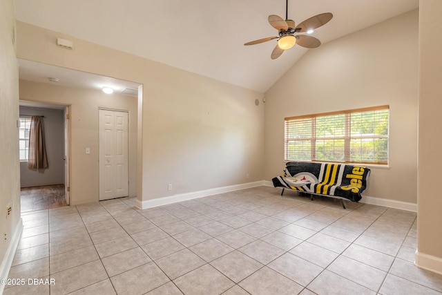 121 Palm Dr, Daytona Beach, FL 32117 - empty room with high vaulted ceiling, light tile patterned floors, a ceiling fan, and baseboards