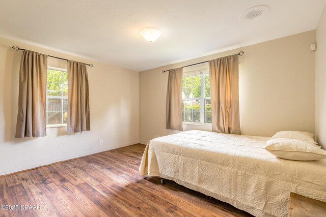 121 Palm Dr, Daytona Beach, FL 32117 - bedroom with wood finished floors and baseboards