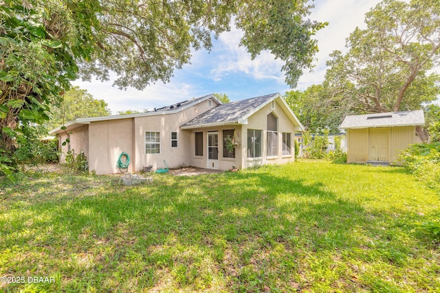 121 Palm Dr, Daytona Beach, FL 32117 - back of house featuring a sunroom, stucco siding, and a yard