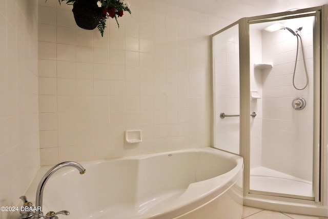 bathroom featuring tile patterned flooring and separate shower and tub