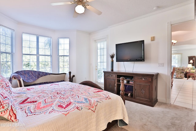 carpeted bedroom featuring ceiling fan, multiple windows, and ornamental molding