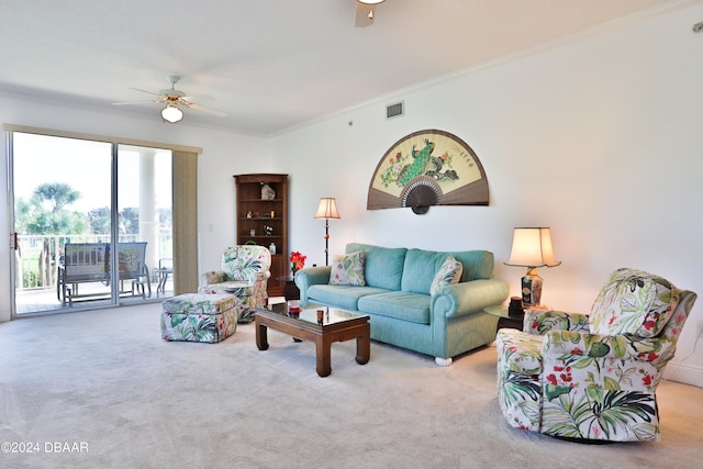 living room featuring ceiling fan, light colored carpet, and ornamental molding