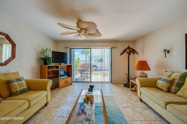 living room with ceiling fan and light tile patterned floors