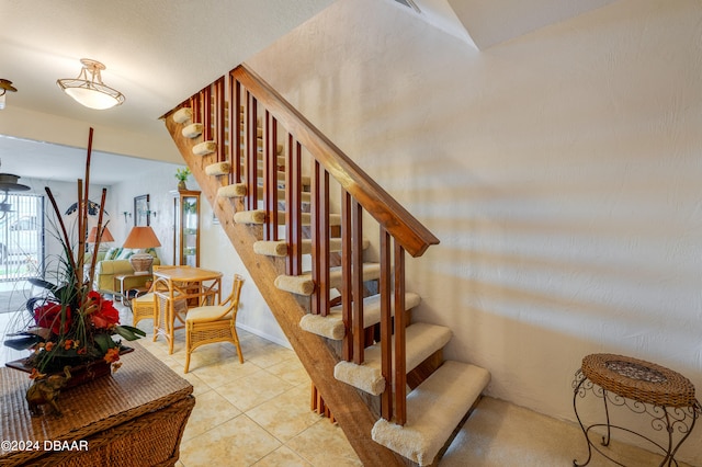 staircase featuring tile patterned floors