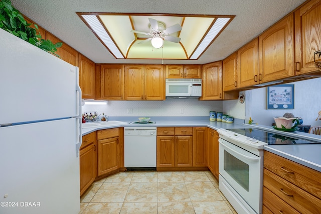 kitchen with white appliances, ceiling fan, a textured ceiling, and light tile patterned floors