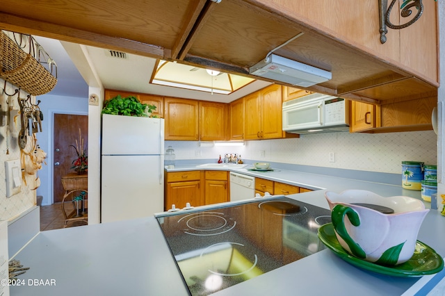 kitchen with white appliances and decorative backsplash