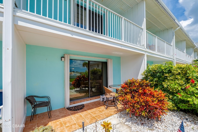 property entrance with a balcony and a patio