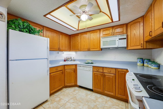 kitchen featuring light tile patterned flooring, a textured ceiling, sink, white appliances, and ceiling fan