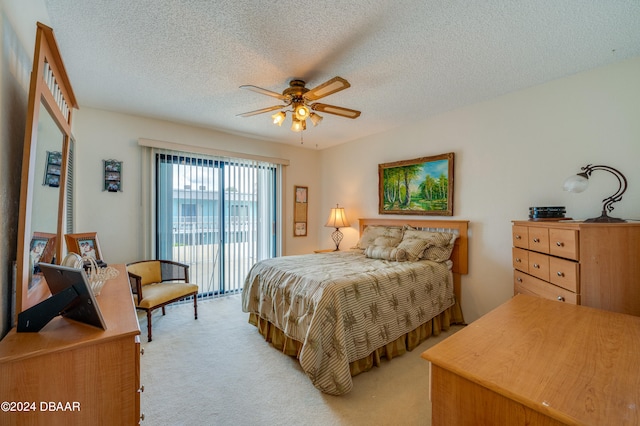 bedroom featuring a textured ceiling, light carpet, ceiling fan, and access to exterior