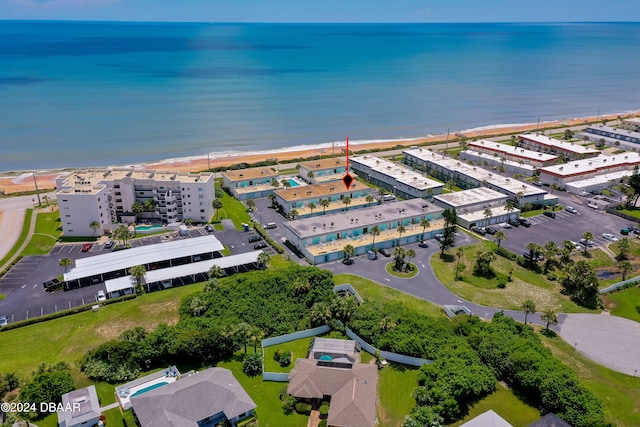 birds eye view of property with a view of the beach and a water view