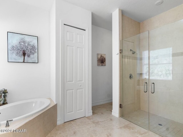 bathroom featuring tile patterned flooring and plus walk in shower