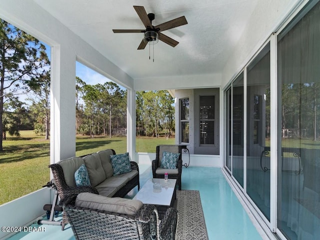 sunroom featuring ceiling fan