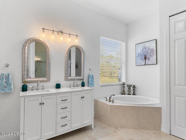 bathroom with tiled bath, tile patterned flooring, and vanity