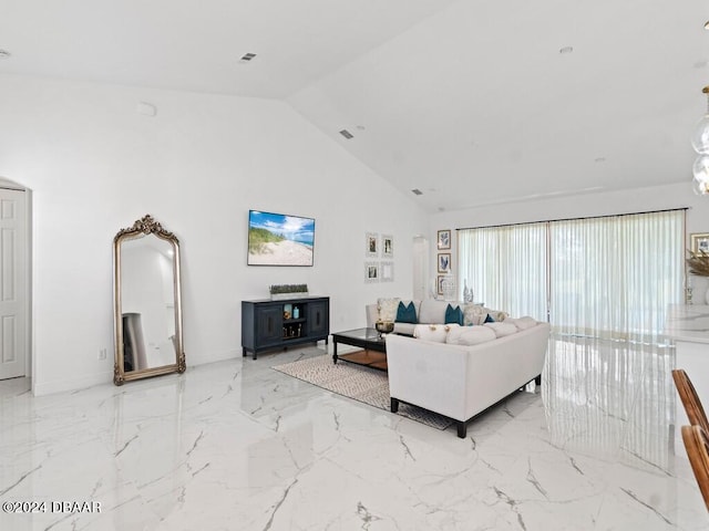 living room with high vaulted ceiling