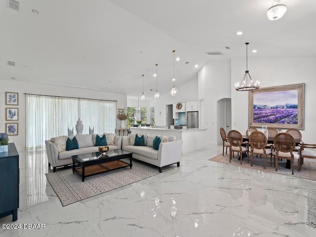 living room featuring vaulted ceiling and a notable chandelier