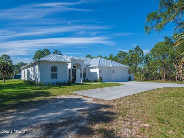 view of front of home featuring a garage and a front lawn