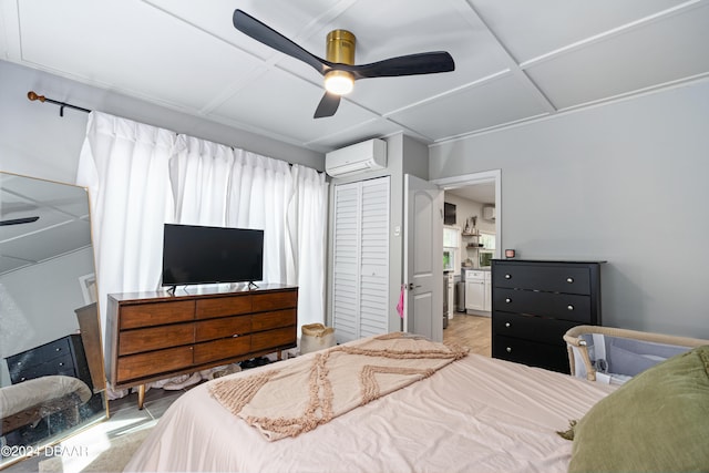 bedroom featuring ceiling fan, a closet, and an AC wall unit