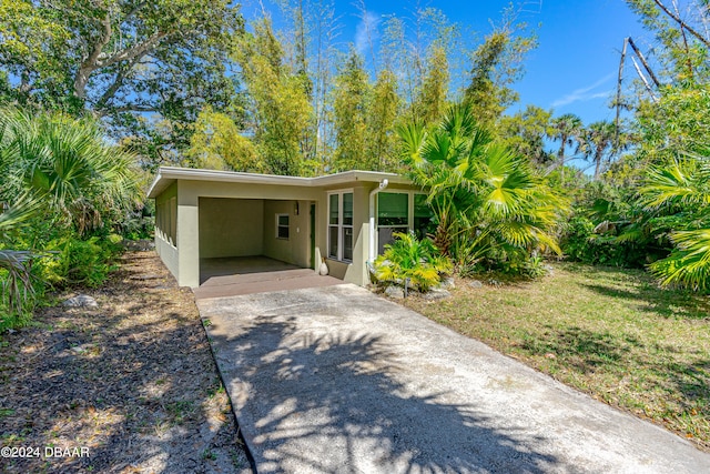 exterior space featuring a front yard and a carport