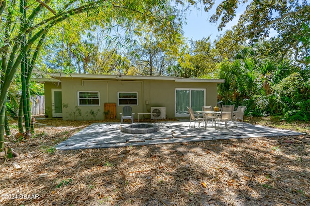 rear view of house featuring an outdoor fire pit, a patio, and ac unit