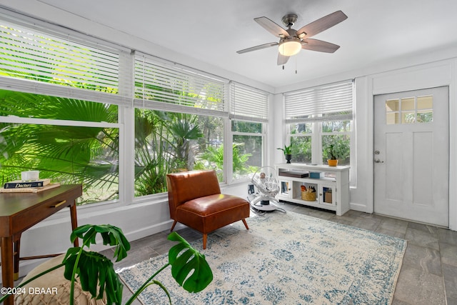 sunroom featuring ceiling fan