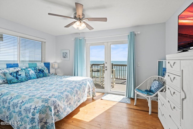 bedroom with ceiling fan, french doors, access to outside, and hardwood / wood-style floors