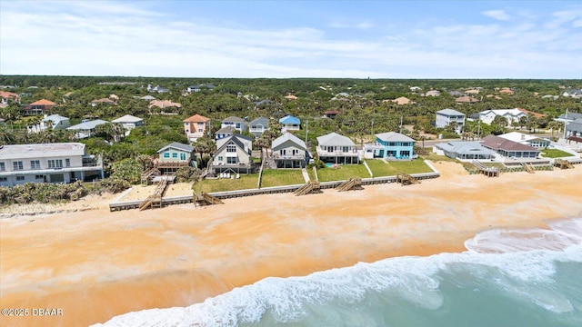 drone / aerial view with a water view and a view of the beach